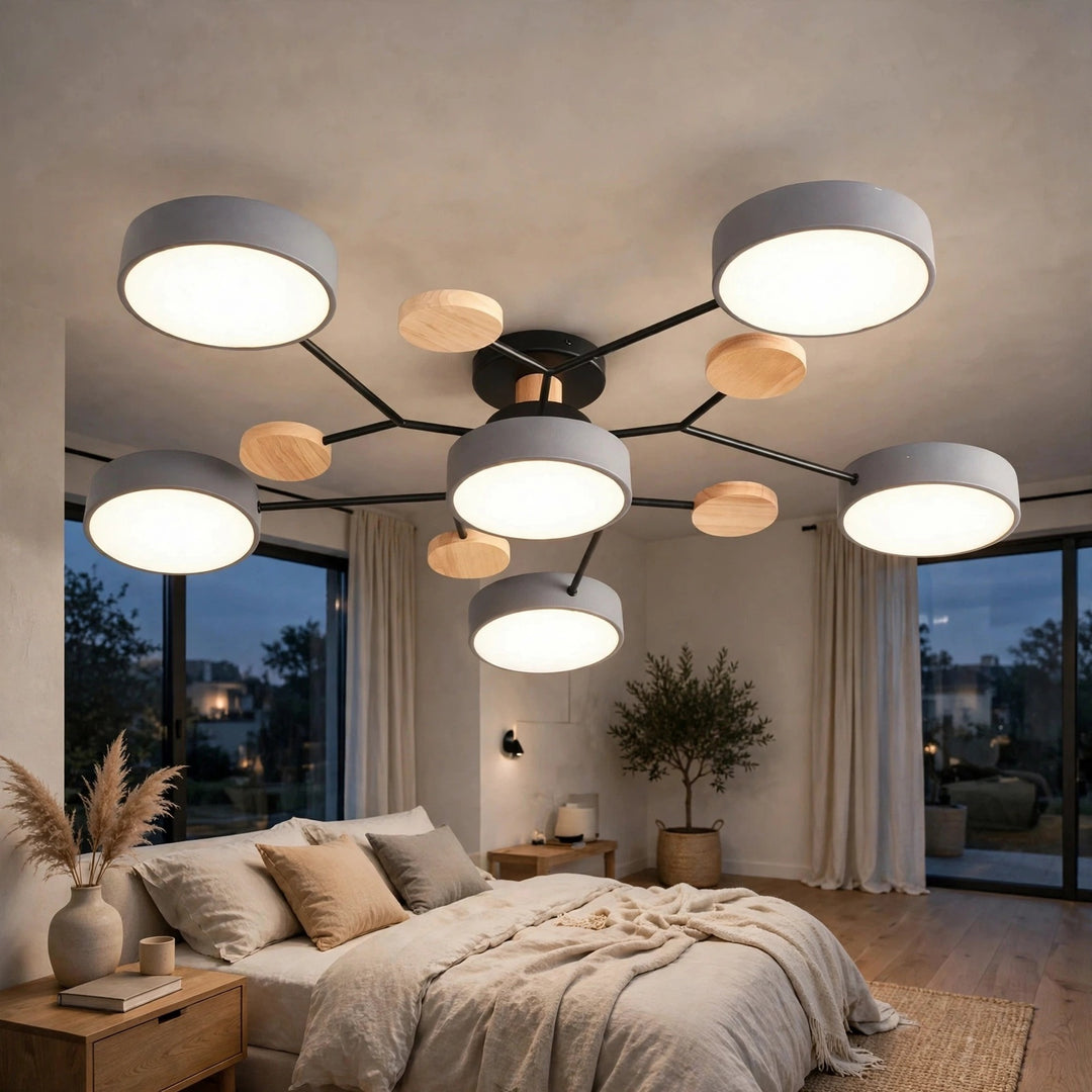 Modern multi-light ceiling fixture with six circular white shades and light wood accents on a black frame, installed in a contemporary bedroom with large windows and a bed.
