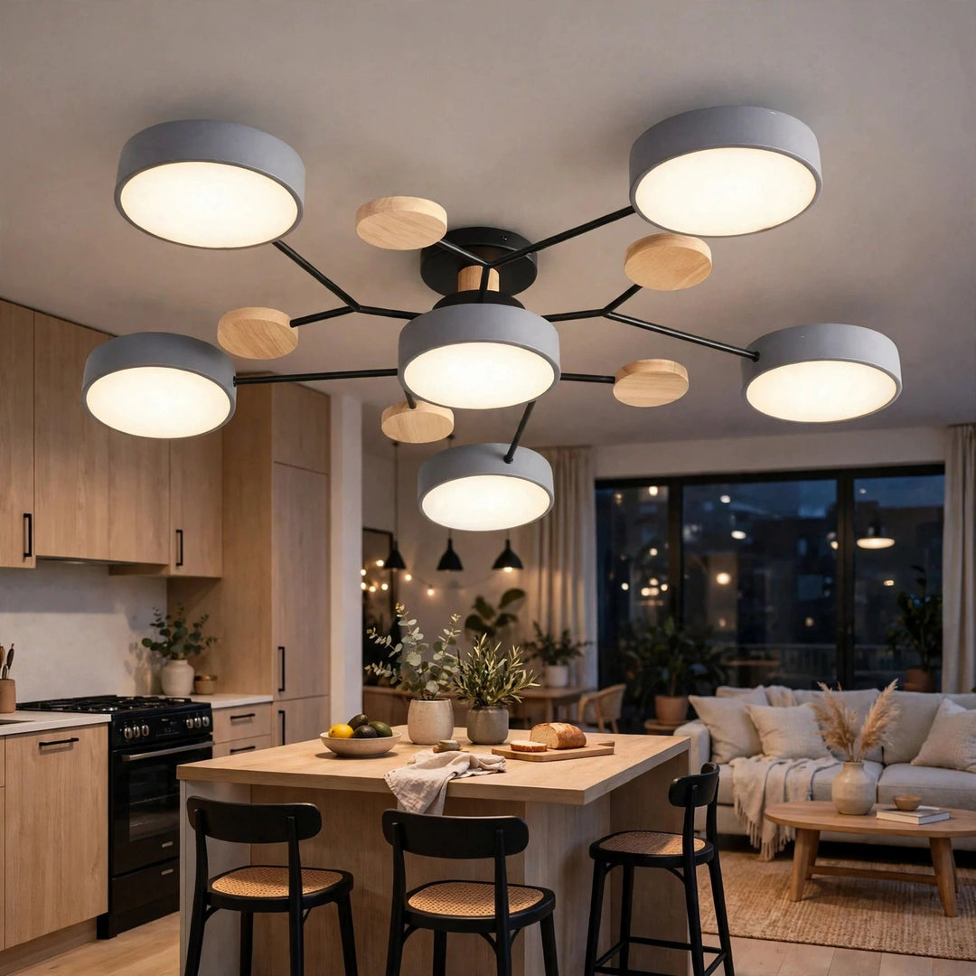 A modern multi-light ceiling fixture with six circular gray shades and several small round wood accents on a black central frame, installed in a bright contemporary kitchen and living room.