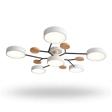 Modern multi-light ceiling fixture with white cylindrical shades, black metal arms, and small round natural wood accents, shown against a plain white background.