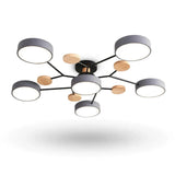 Modern ceiling light fixture with six circular gray shades, a black central frame, and five natural wood accent discs, shown against a plain white background.