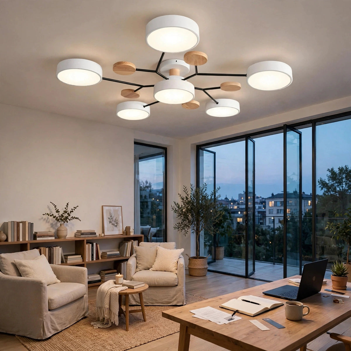 A modern multi-light ceiling fixture with white cylindrical shades and light wood circular accents, mounted on a black central frame in a bright, contemporary living room with large floor-to-ceiling windows.