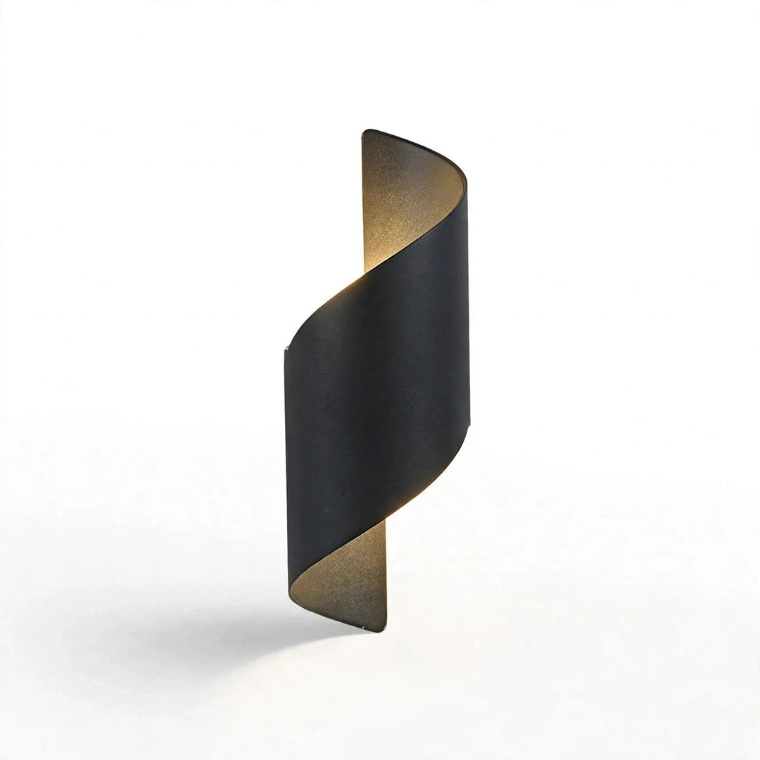 A modern spiral-shaped wall sconce with a matte black outer finish and a warm gold-toned inner lining, shown against a clean white background.