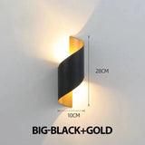 Black and gold spiral wall sconce on a gray background has size labels showing 28 cm height and 10 cm width.