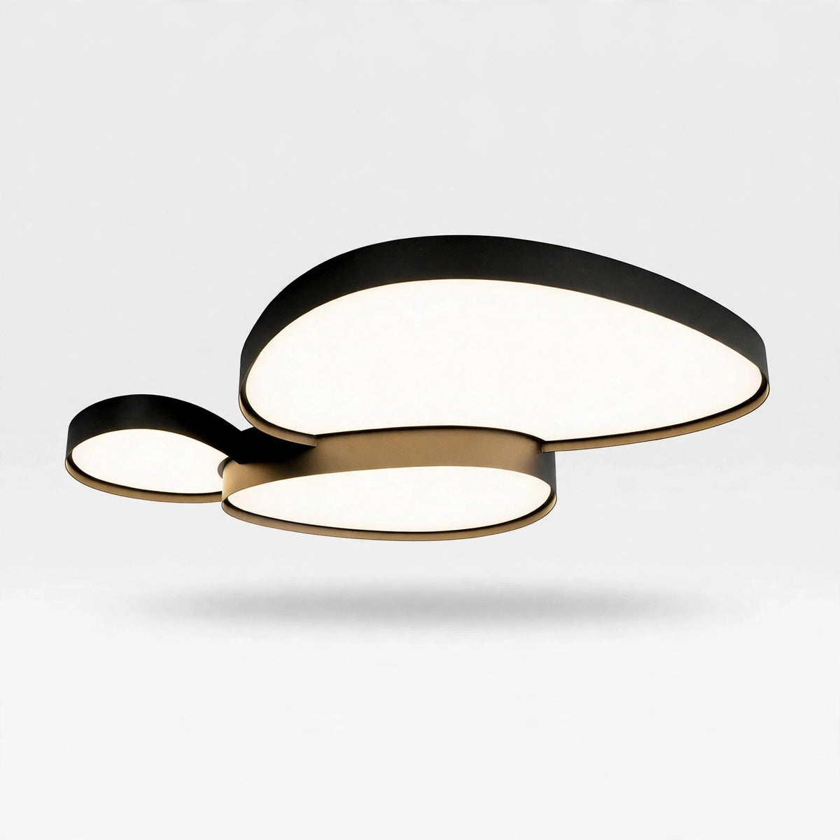 A modern three-light ceiling fixture with organic, overlapping cloud-like shapes. The lights are illuminated with a warm white glow, framed by matte black outer rings and brushed gold inner trim, shown floating against a light gray background.