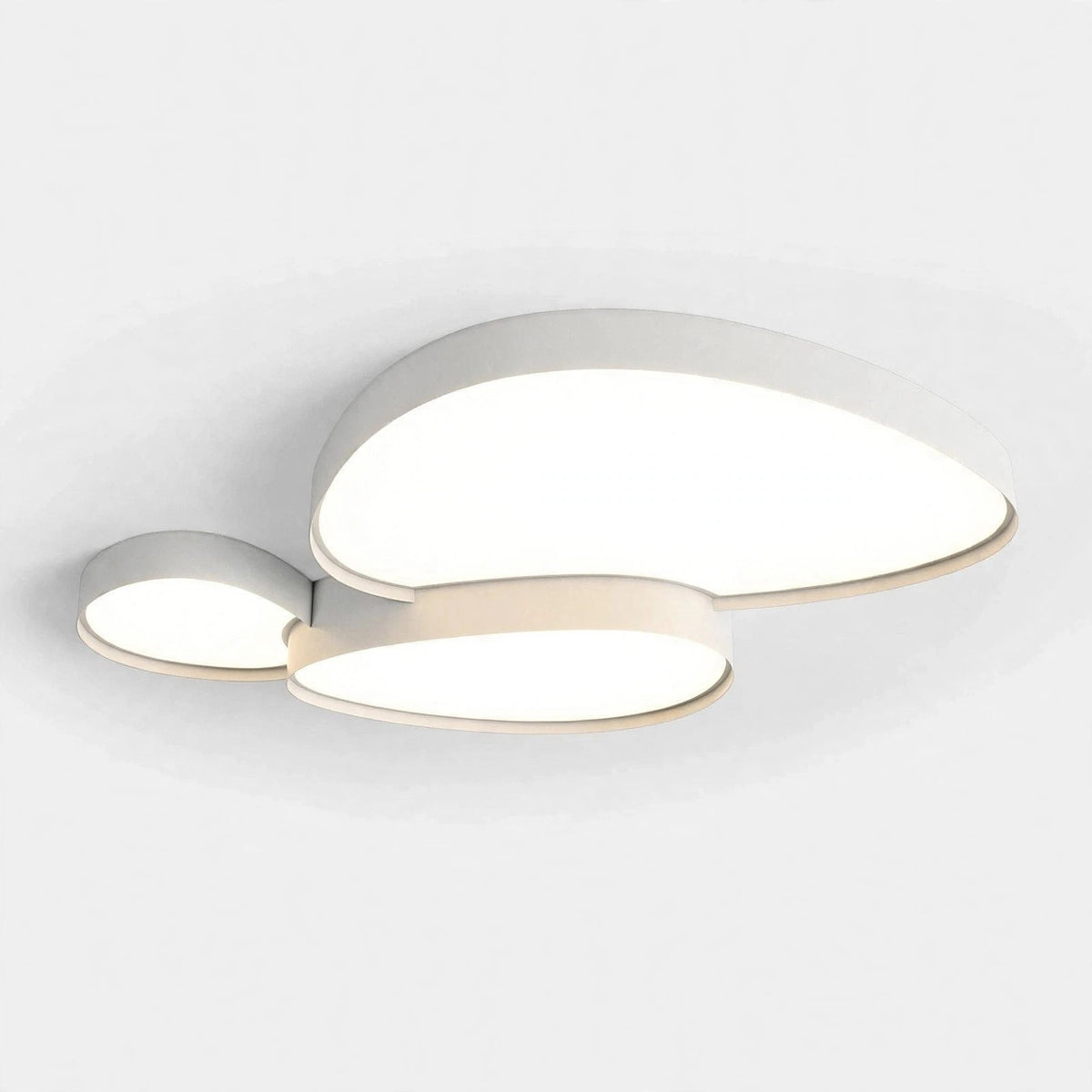 A modern three-light ceiling fixture with organic, flowing shapes in a warm white finish, shown illuminated against a clean white ceiling.