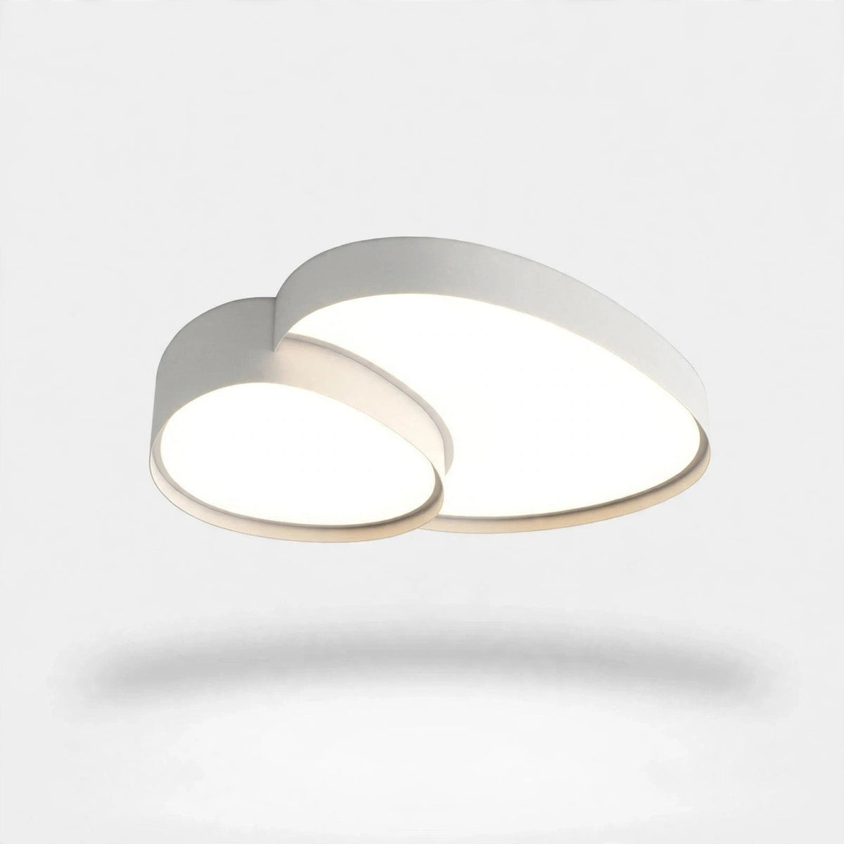 A modern cloud-shaped ceiling light fixture with a white outer frame and a warm beige inner trim, shown illuminated against a clean white background.
