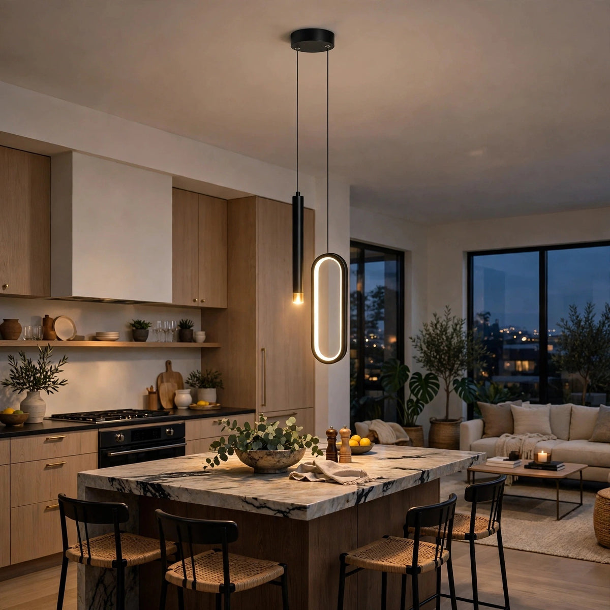 Modern kitchen island with a marble countertop and black bar stools, illuminated by two contemporary pendant lights hanging above. The background shows a contemporary kitchen, living room, and large windows at dusk.