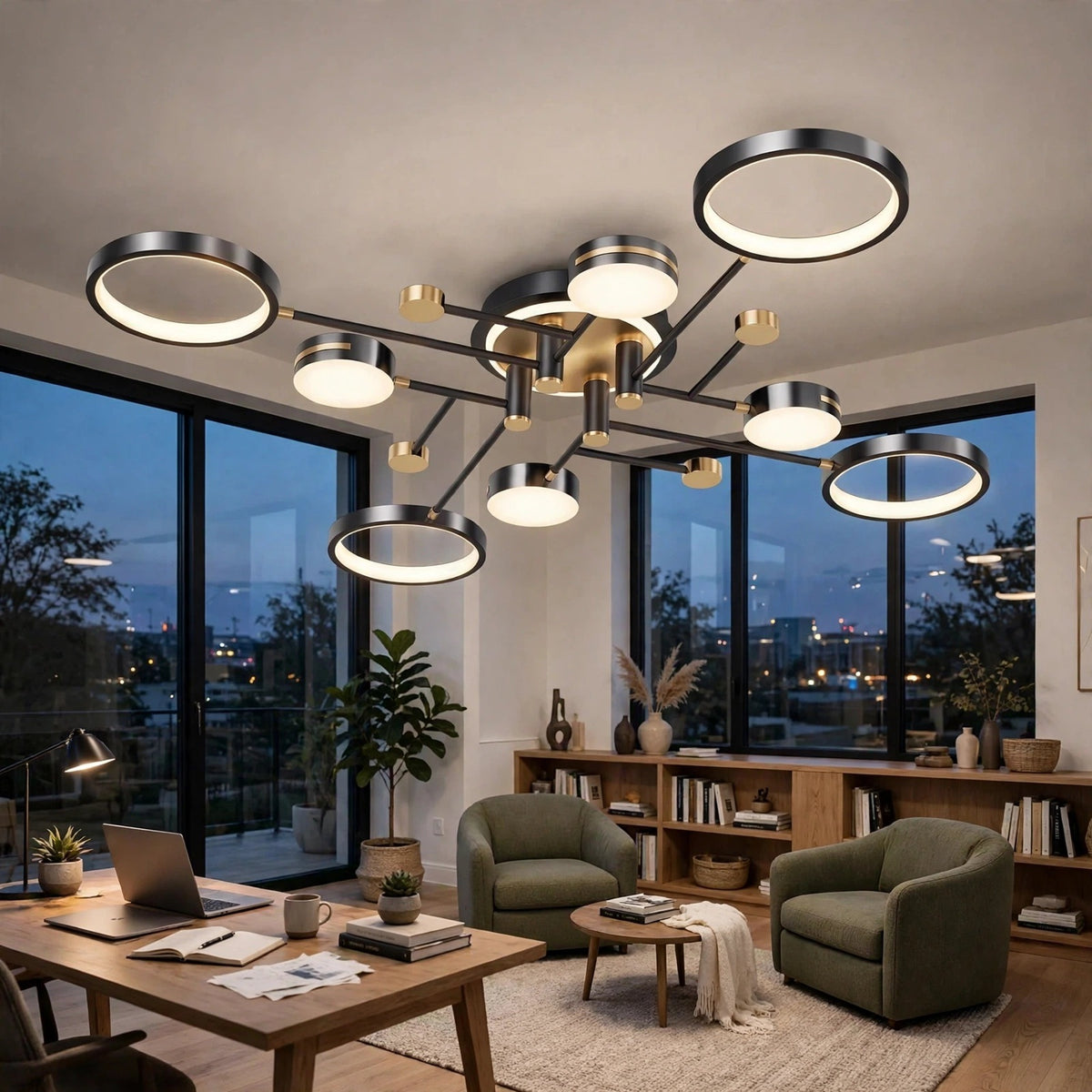 A black ceiling light with circular rings and gold accents glows above a home office with green armchairs and a wooden desk.