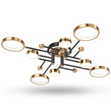 Modern ceiling light fixture with a black metal frame and multiple circular gold-rimmed shades, shown against a plain white background.