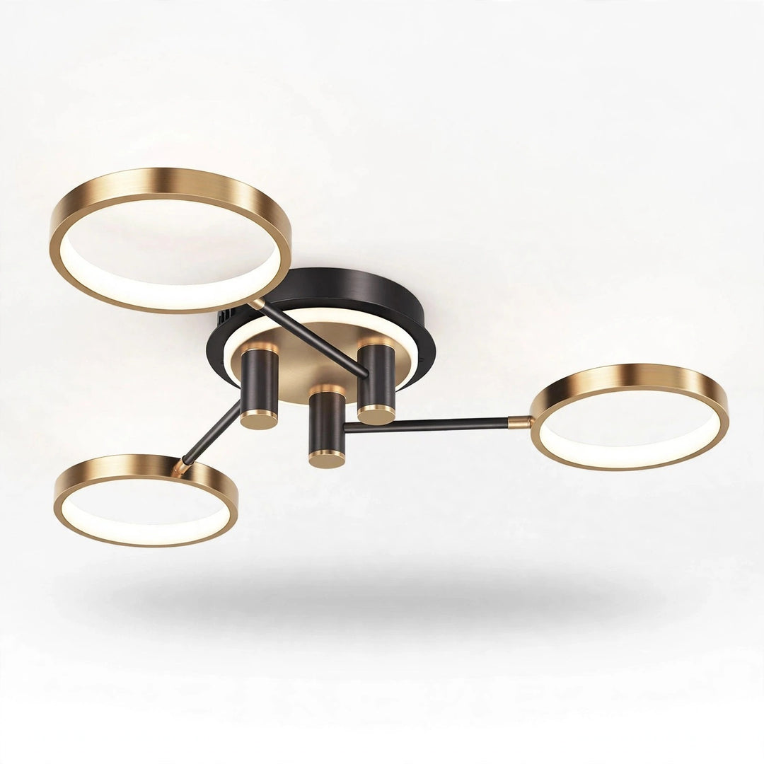 Modern three-light ceiling fixture with circular gold-toned shades and a matte black central body, shown against a plain white ceiling.