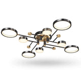 Modern multi-light ceiling fixture with a black metal frame, gold accents, and circular glass shades, shown against a plain white background.