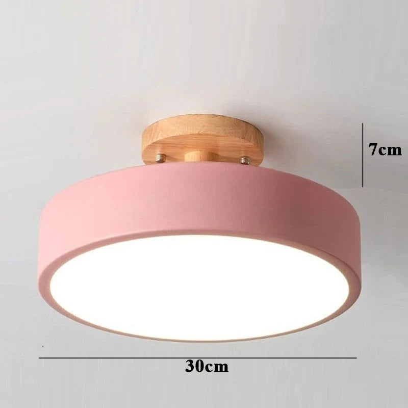 A pink flush-mount ceiling light with a natural wood ceiling canopy and a white diffuser, shown with dimension lines indicating a width of 30cm and a height of 7cm.