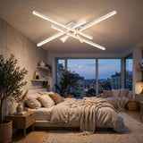 Modern ceiling light fixture with multiple linear LED light bars in a white finish, mounted on the ceiling of a contemporary bedroom with large windows and a city view at dusk.