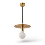 A modern pendant light fixture with a brushed brass/gold ceiling canopy and circular shade, suspended by a black cord from an Edison-style glass bulb, shown against a plain white background.
