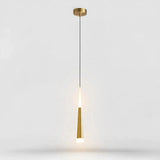 A modern pendant light fixture with a brushed gold ceiling canopy and a tapered gold shade, suspended by a thin black cord against a light gray background.