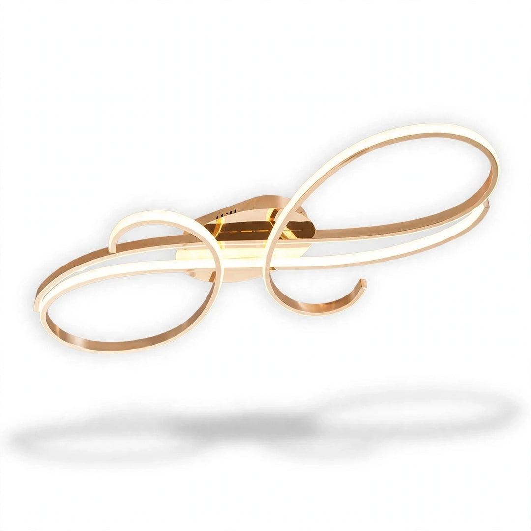 A gold ceiling light with sweeping looped bands and glowing white LED edges appears against a white background.