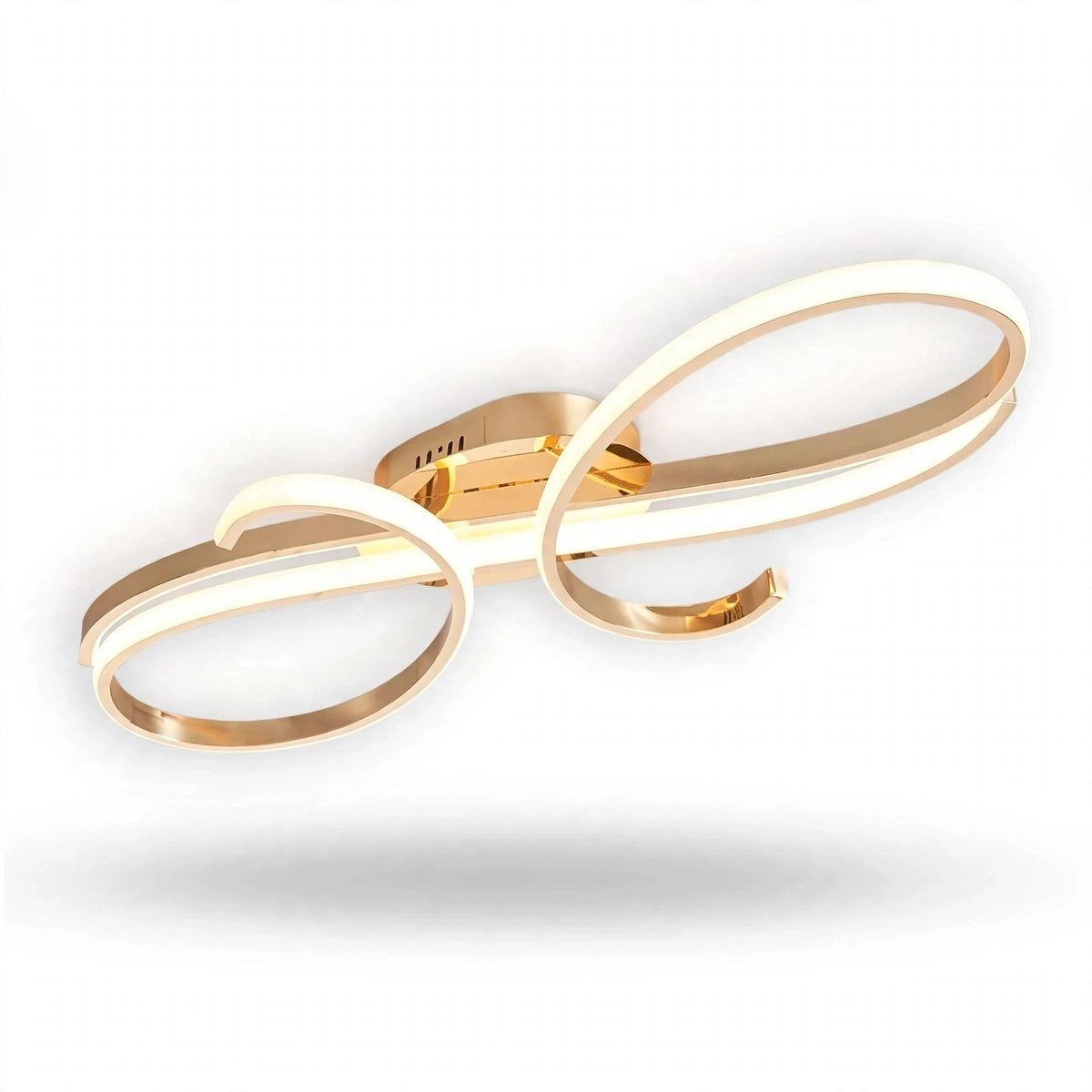 A gold ceiling light with overlapping curved bands and a reflective central mount is shown illuminated against a white background.