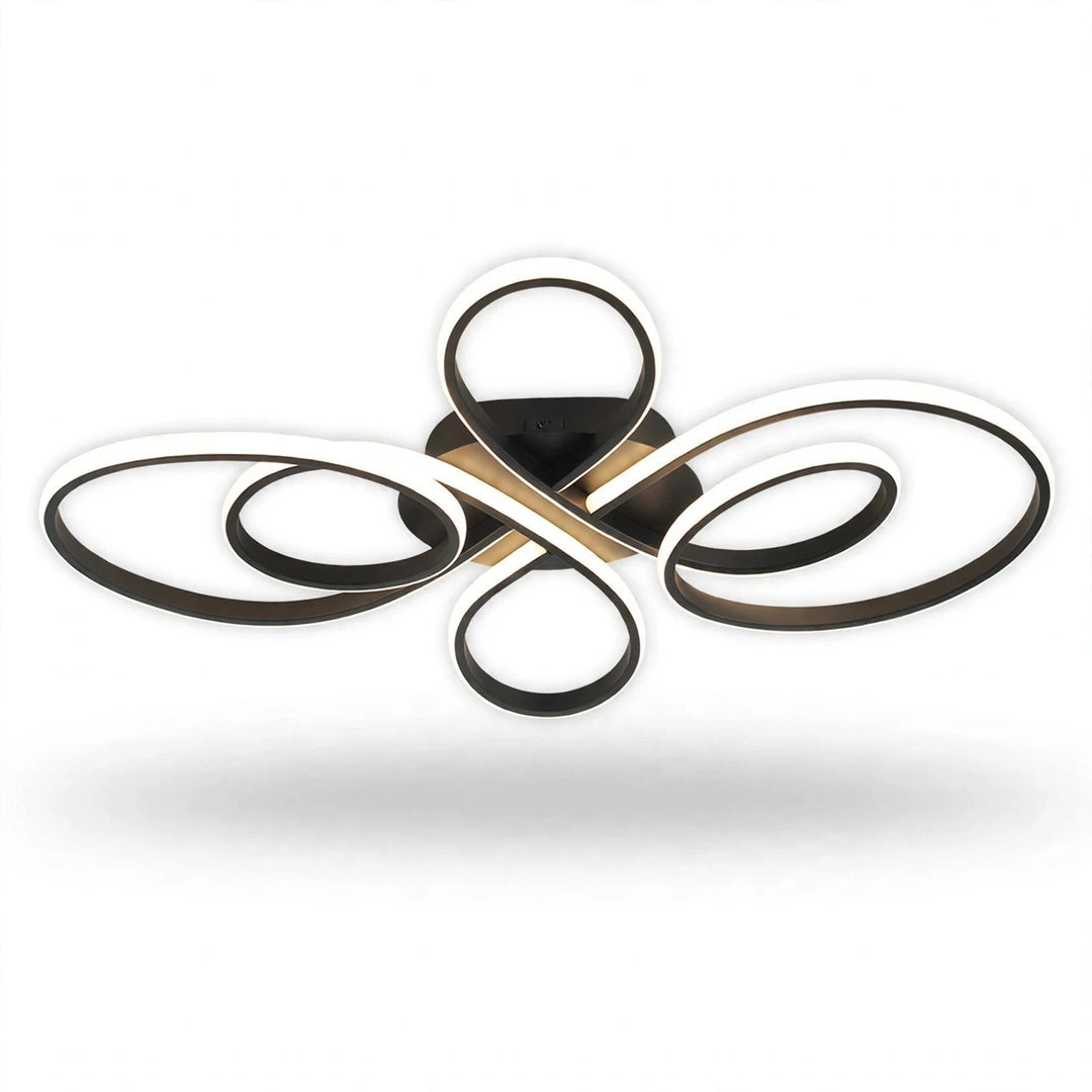 A modern multi-light ceiling fixture with four interlocking circular and looped metal elements in a brushed gold and black finish, shown against a plain white background with a soft drop shadow.