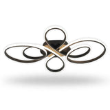 A modern multi-light ceiling fixture with four interlocking circular and looped metal elements in a brushed gold and black finish, shown against a plain white background with a soft drop shadow.