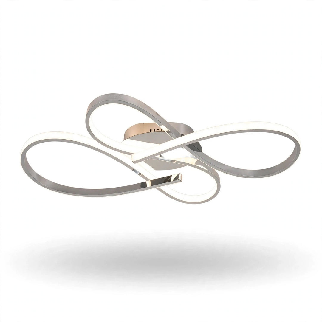 A modern three-ring LED ceiling light fixture with a polished chrome finish and a warm gold accent plate, shown floating against a solid white background.
