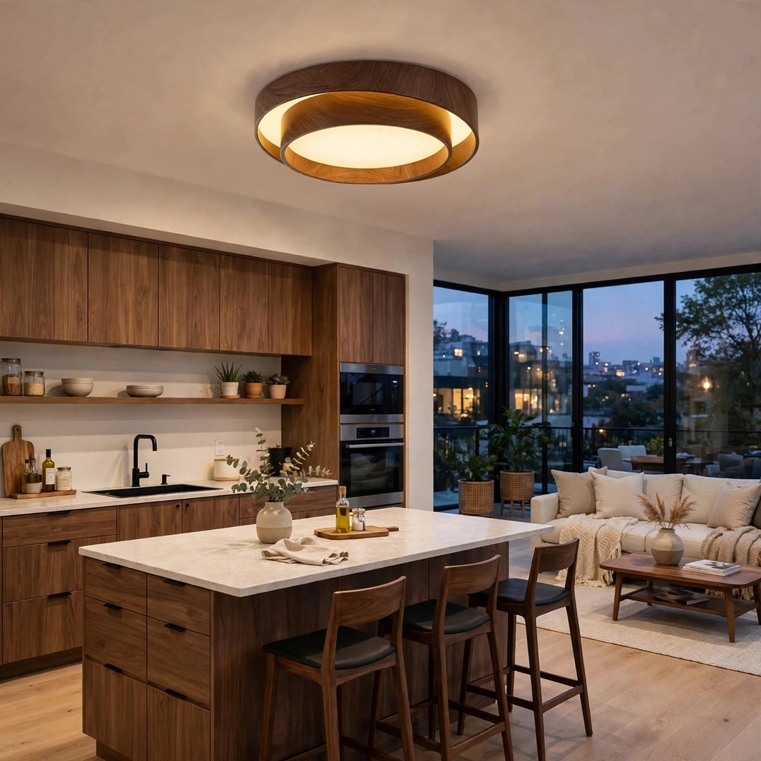 A modern circular ceiling light with a dark wood frame and warm glowing LED, installed in a contemporary kitchen and living room setting.