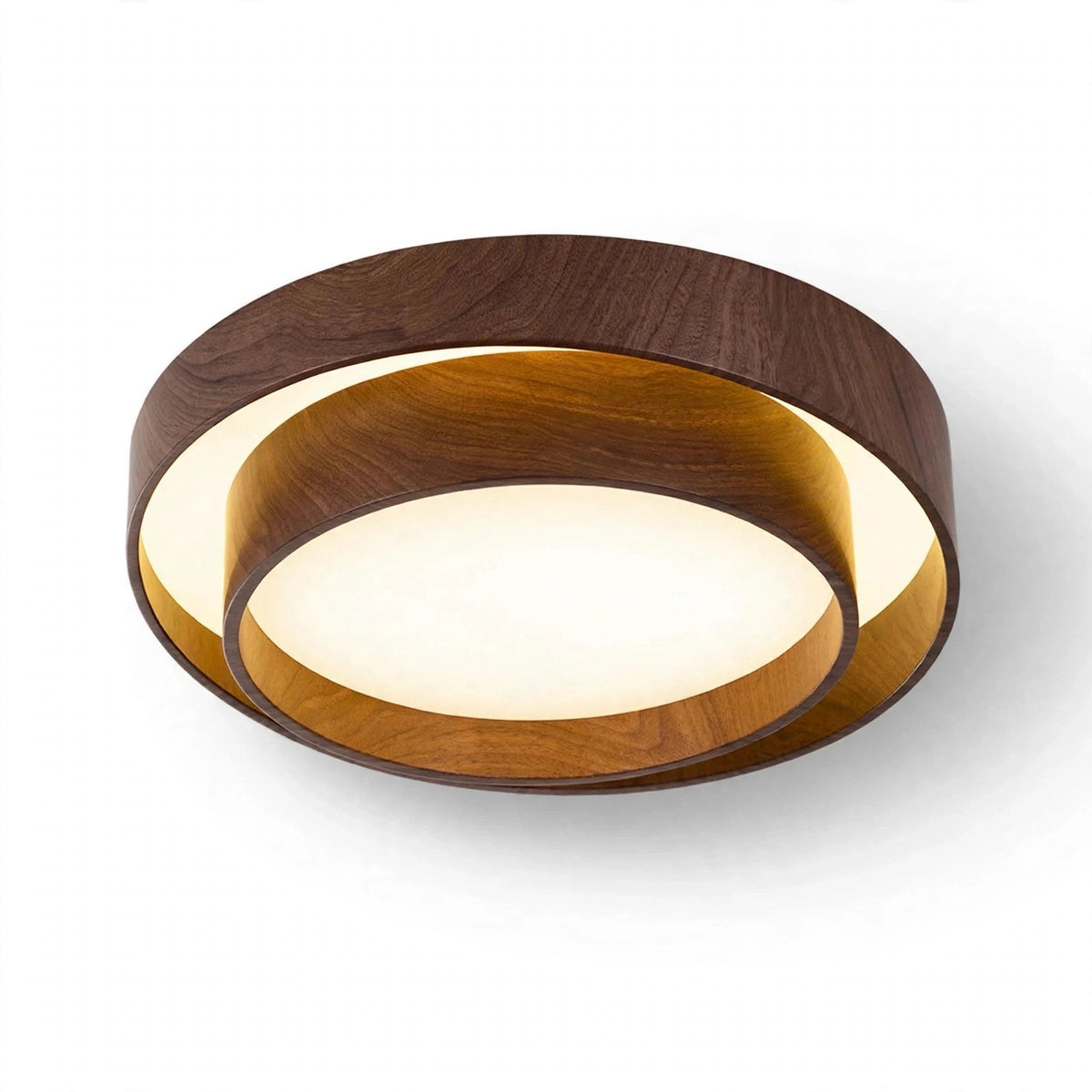 A modern flush-mount ceiling light fixture featuring concentric circular rings in dark walnut wood and warm golden-brown wood, with a glowing warm white LED light in the center, shown against a plain white background.