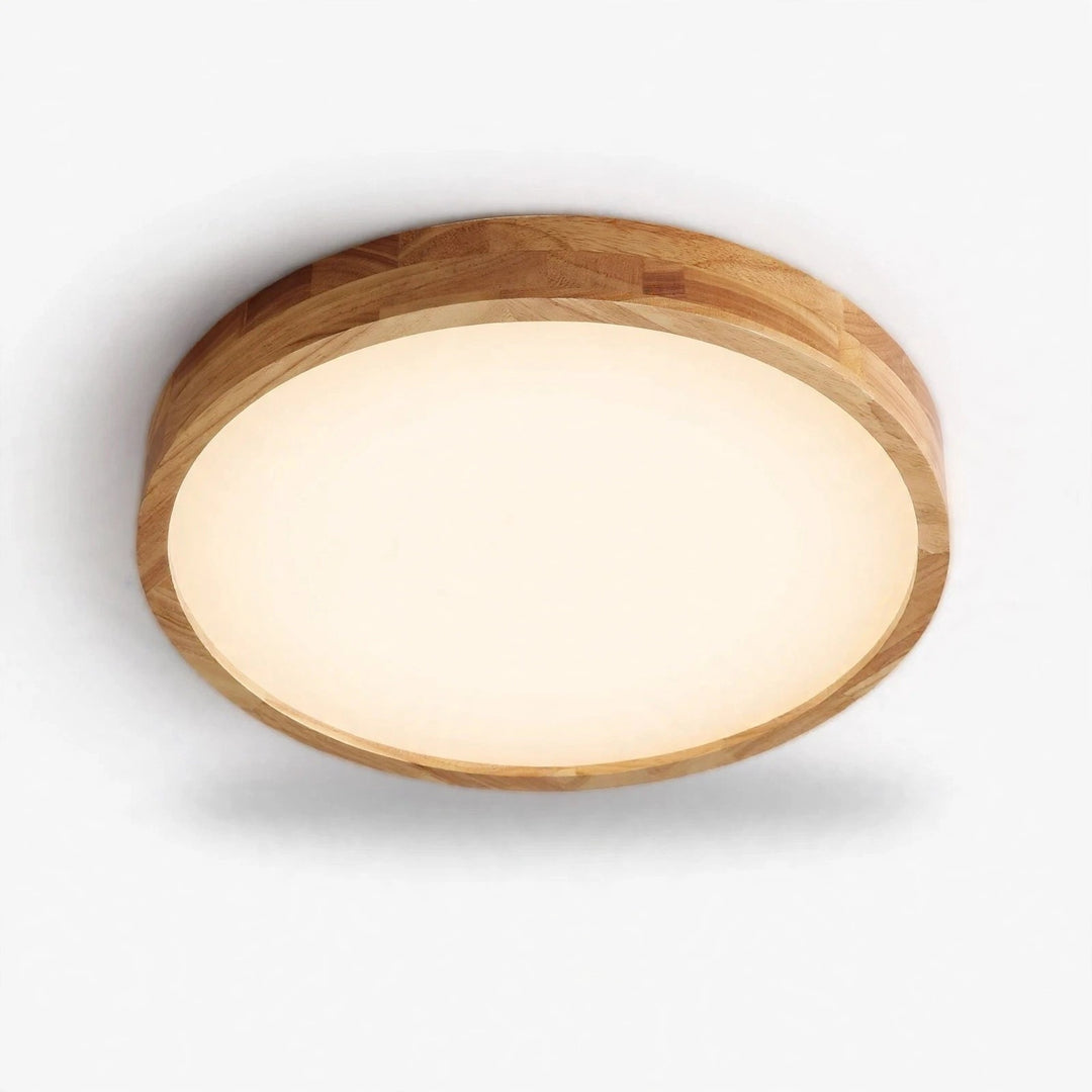 A round flush-mount ceiling light with a natural wood frame and a warm white frosted glass diffuser, shown against a plain white background.