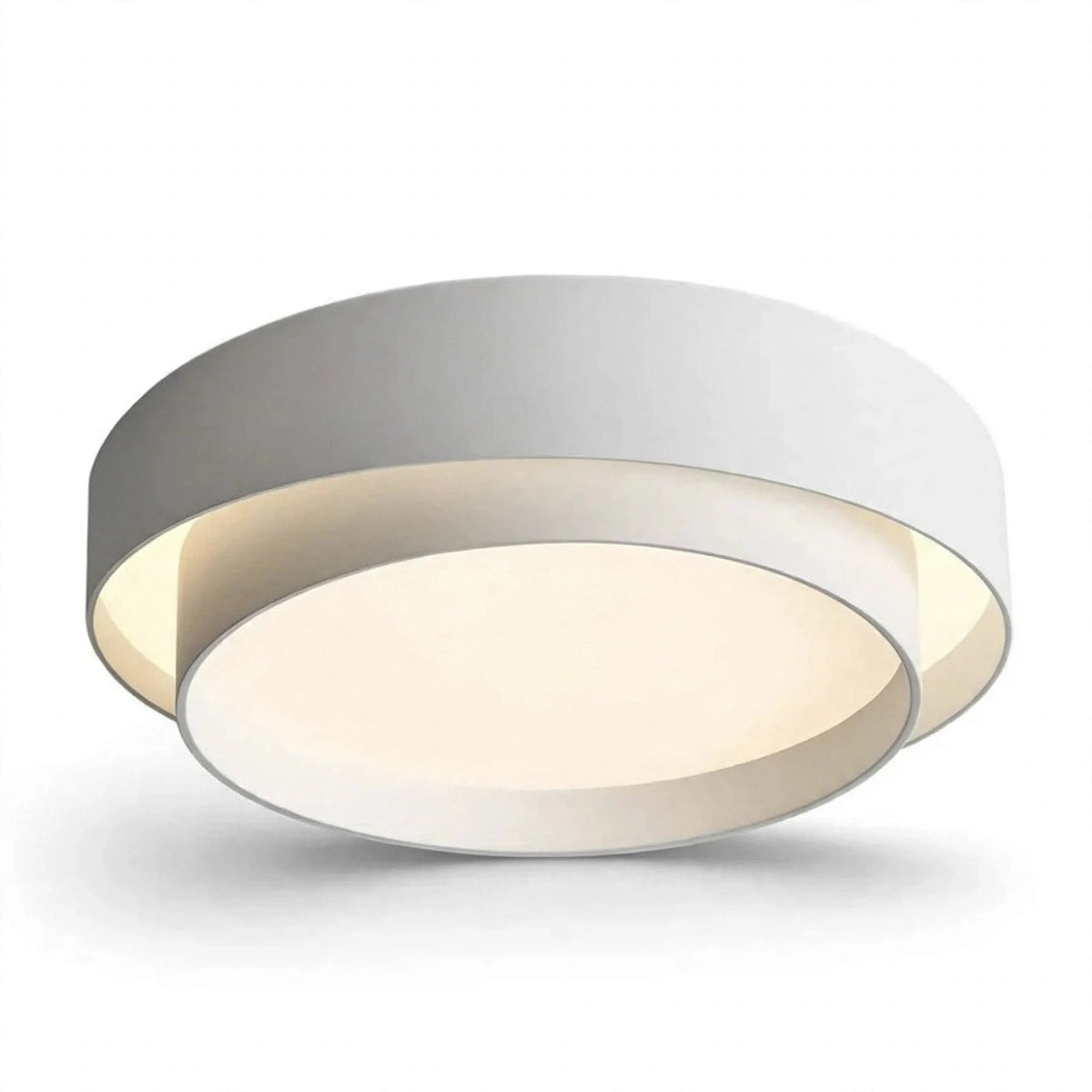 A modern circular flush-mount ceiling light fixture with a white outer ring, a warm cream-colored inner ring, and a silver metallic rim, shown against a plain white background.