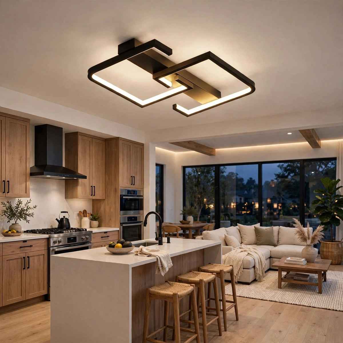 Modern geometric LED ceiling light fixture with black and gold metal frames and warm white illumination, shown installed in a contemporary open-plan kitchen and living room.