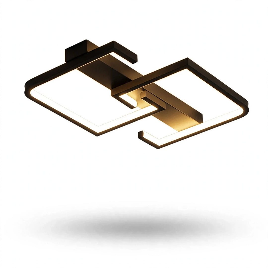 Modern geometric ceiling light fixture with a matte black frame and warm gold-toned metallic accents, shown floating against a solid white background with a soft shadow underneath.