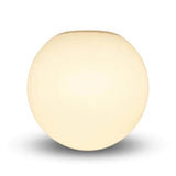 White glass globe wall sconce appears warm cream against a white background, with a soft gray shadow beneath.
