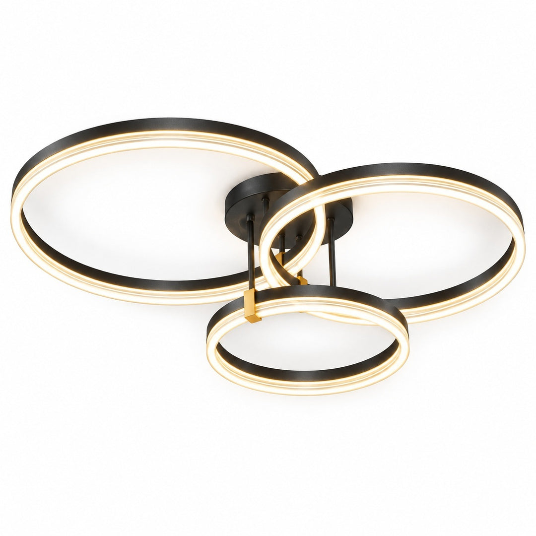 Modern three-ring LED ceiling light fixture in black with a warm gold accent, shown illuminated against a solid white background.