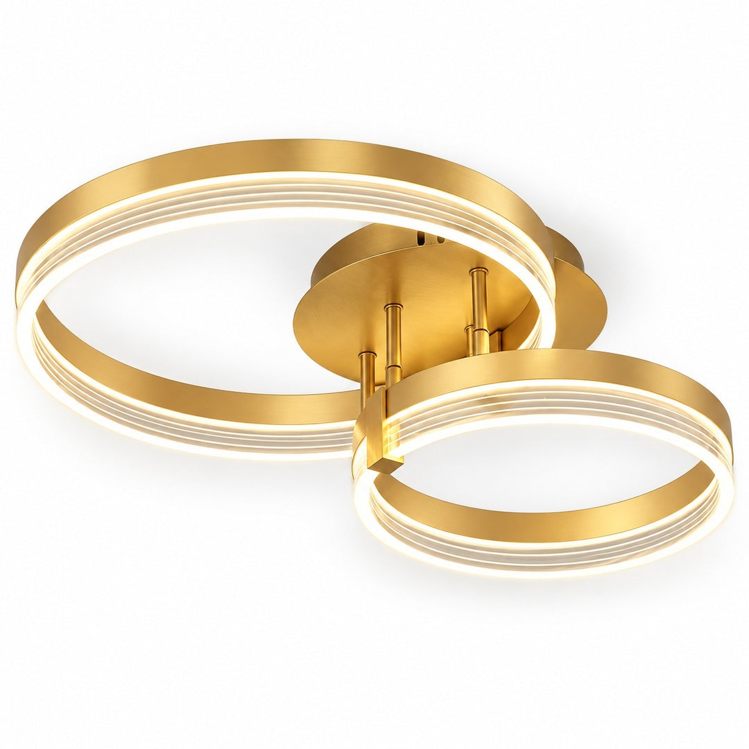 Modern ceiling light fixture with two interlocking circular LED rings in a brushed gold finish, shown against a plain white background.