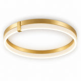 A modern flush-mount ceiling light fixture with a circular design, featuring a brushed gold metal outer frame and a white diffuser that glows with warm light. A small gold accent tab is visible on the upper left side of the frame.