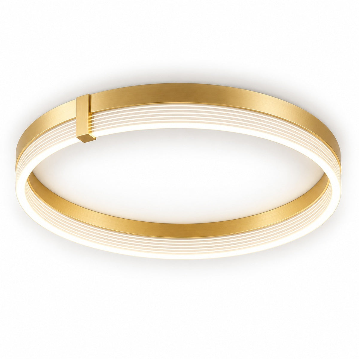 A modern flush-mount ceiling light fixture with a circular design, featuring a brushed gold metal outer frame and a white diffuser that glows with warm light. A small gold accent tab is visible on the upper left side of the frame.