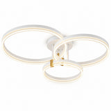 A modern three-ring LED ceiling light fixture in white with a small gold accent, shown against a solid white background.