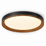 A round flush-mount ceiling light fixture featuring a warm white frosted glass diffuser, a medium brown wood grain outer ring, and a matte black inner rim, shown against a plain white background.
