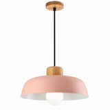 A modern pendant light fixture with a dusty pink metal shade, a natural wood ceiling canopy and collar, and a black hanging cord. A white frosted globe bulb is visible inside the shade.