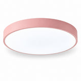 Round flush-mount ceiling light with a pink rim and white diffuser, viewed from below against a white background.