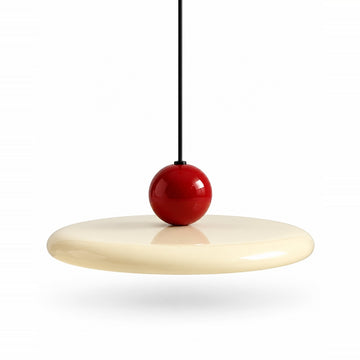 Pendant light with a cream disc shade, glossy red sphere, and black suspension cord against a white background.