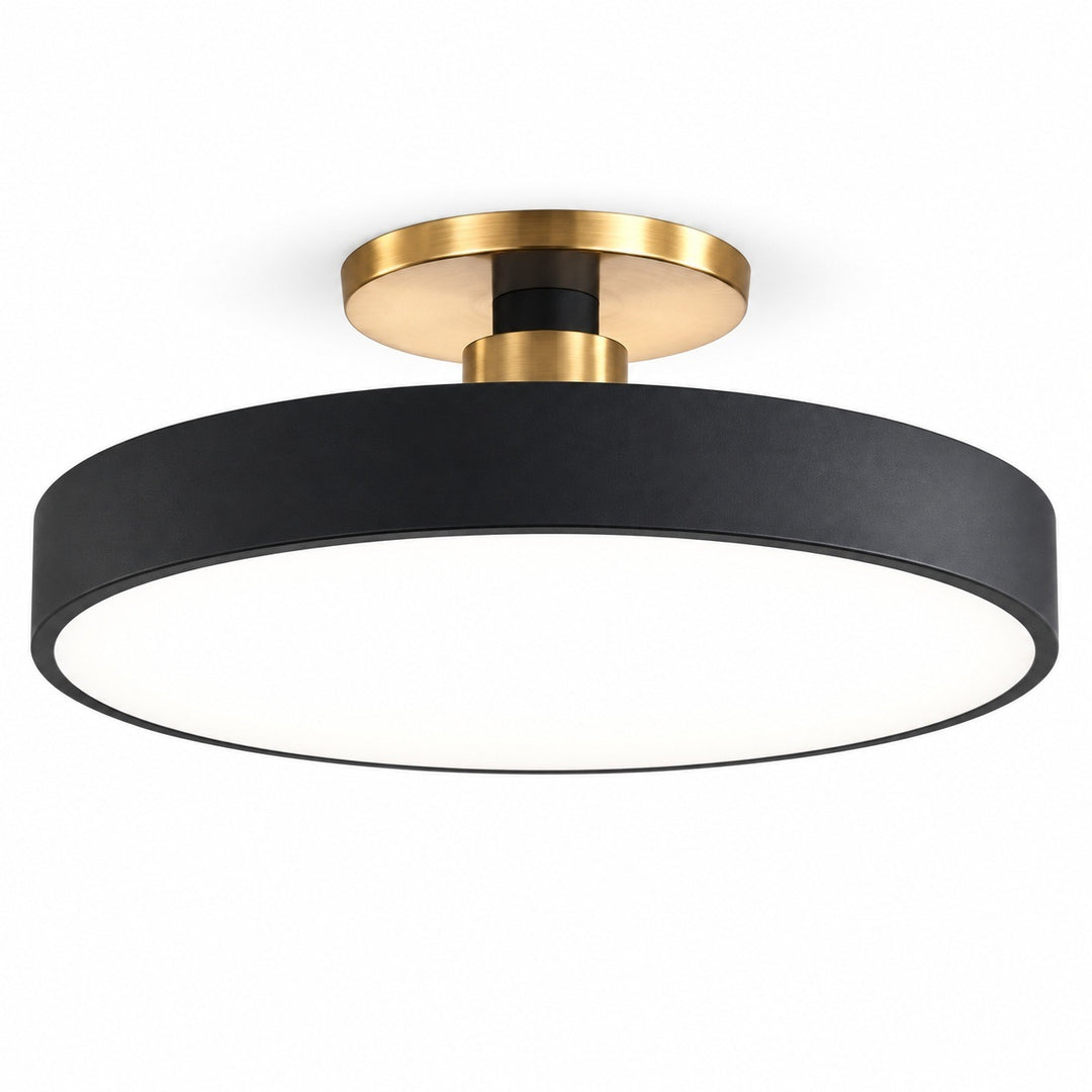 A modern semi-flush mount ceiling light fixture featuring a matte black cylindrical shade and brushed gold metal hardware, shown against a solid white background.