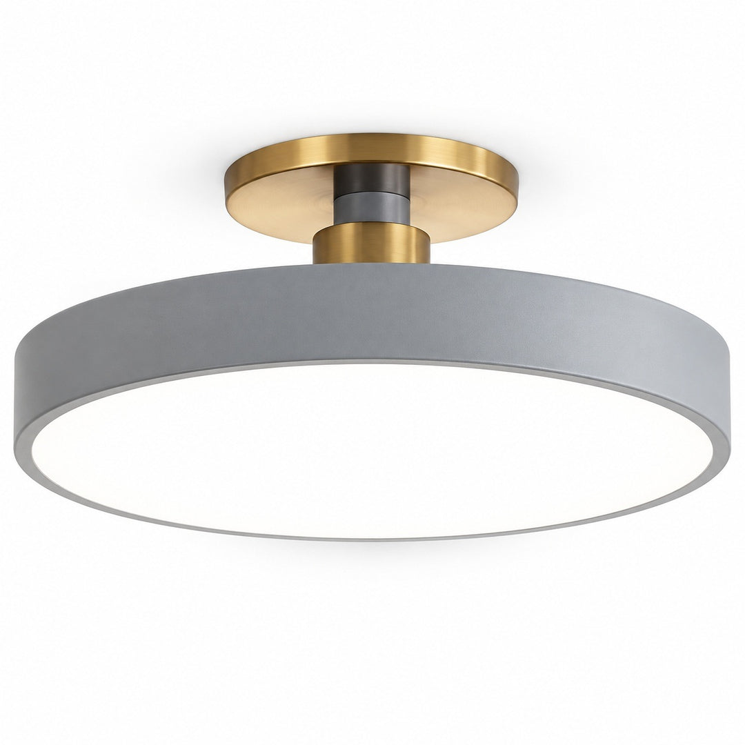 A modern semi-flush mount ceiling light featuring a wide, matte gray circular shade and a brushed brass metal ceiling mount, shown against a solid white background.