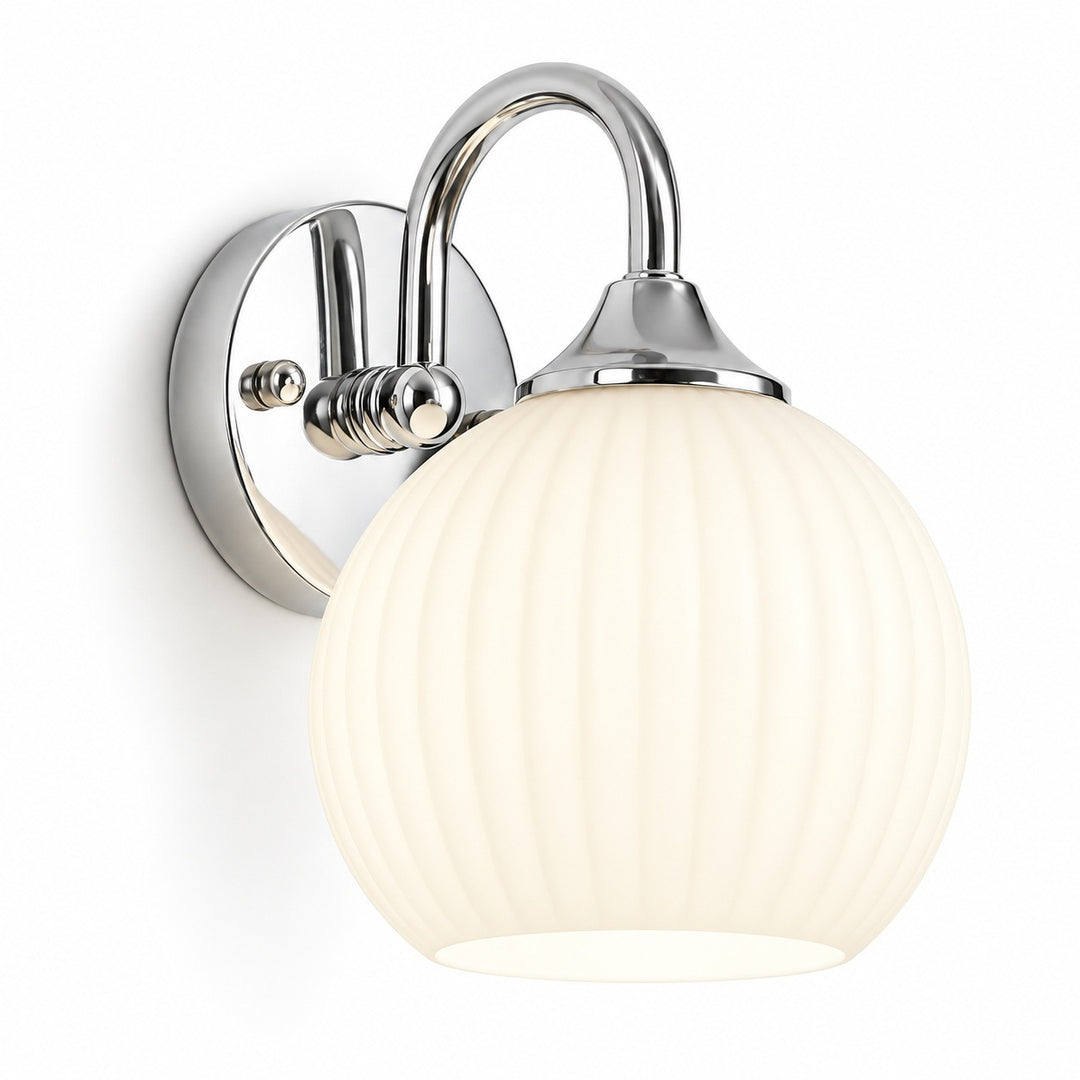 Chrome wall sconce with a curved arm, round backplate, and glowing ribbed white glass shade against a white background.