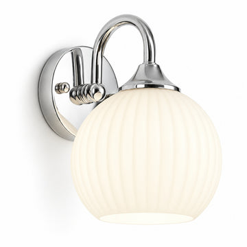 Chrome wall sconce with a curved arm, round backplate, and glowing ribbed white glass shade against a white background.