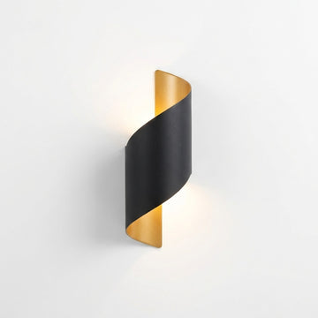 A modern spiral wall sconce with a matte black outer band and a brushed gold inner accent, shown illuminated against a clean white background.