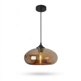A modern pendant light with a rounded, teardrop-shaped smoked amber glass shade and a matte black ceiling canopy and cord, shown against a plain white background.
