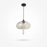 A modern pendant light with a clear smoked glass dome shade and a black ceiling canopy and cord, shown against a plain white background.
