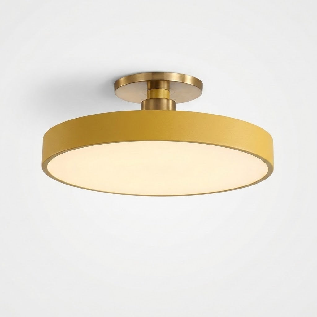 A modern semi-flush mount ceiling light fixture with a matte gold cylindrical shade and a warm white illuminated diffuser, shown against a plain white background.