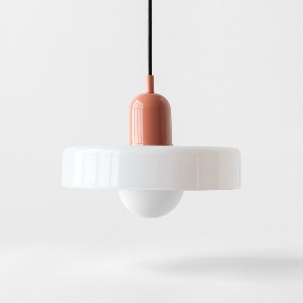 A modern pendant light with a wide white flared shade, a white dome diffuser below, and a terracotta-colored central connector on a black cord, shown against a clean white background.
