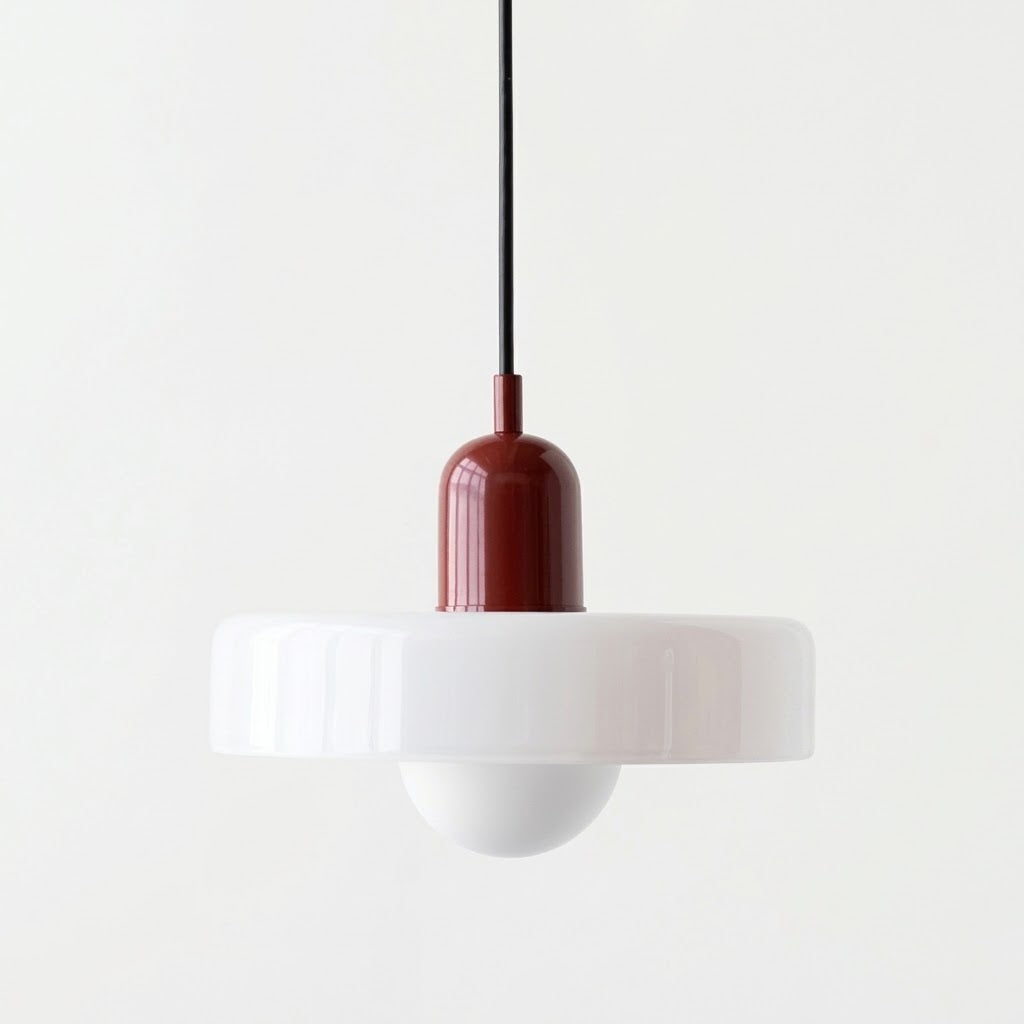 A modern pendant light with a wide white flared shade, a white globe bulb, and a glossy dark red metallic neck, suspended by a black cord against a plain white background.